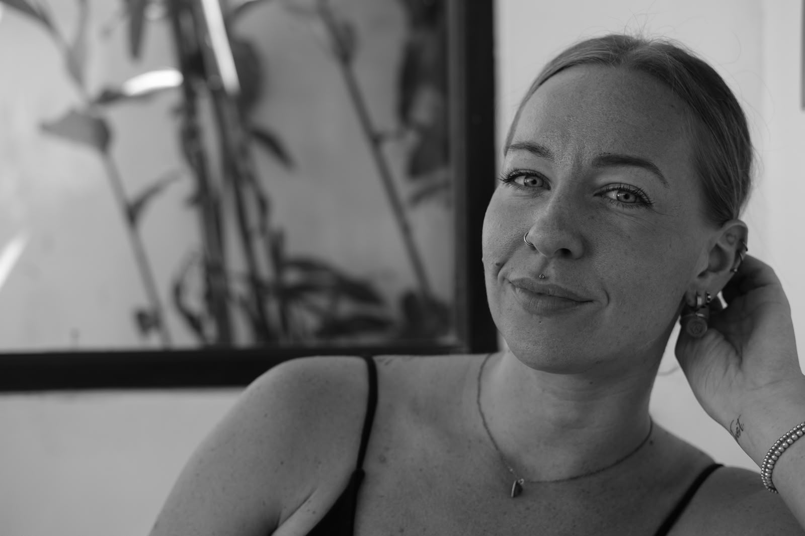 Black and white photo of Lottie relaxed, smiling gently